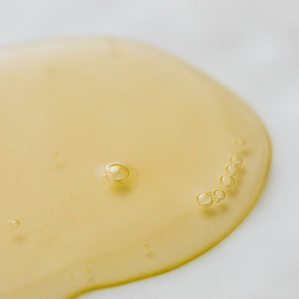 Transparent yellowish liquid on white surface