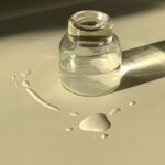 Grow Your Lashes to New Heights with Aloe Vera: The Ultimate Eyelash Booster Glass jar with transparent liquid placed on white table