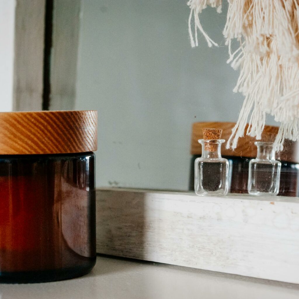 Perfume bottle and skin care product jar placed near mirror