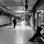 A man sitting on a bench in a subway station