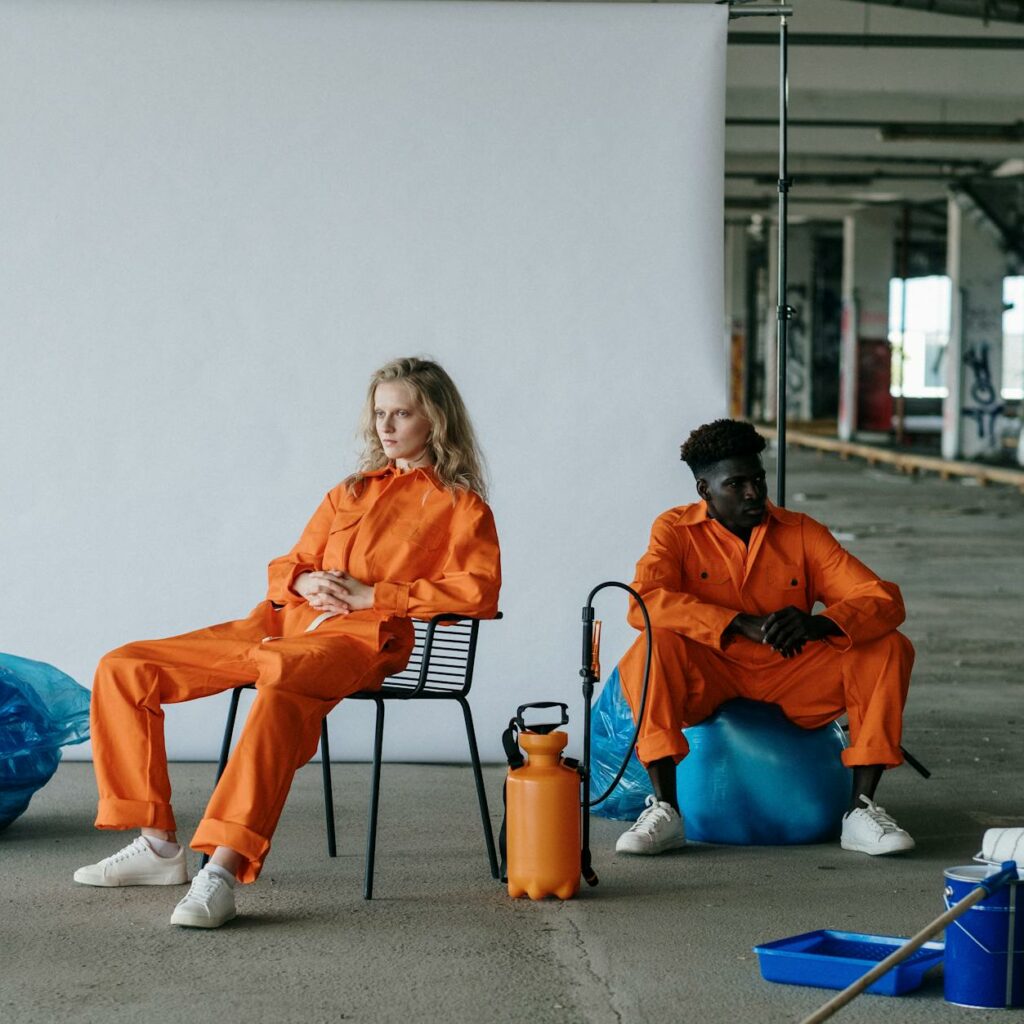 Couple in Orange Overalls Sitting