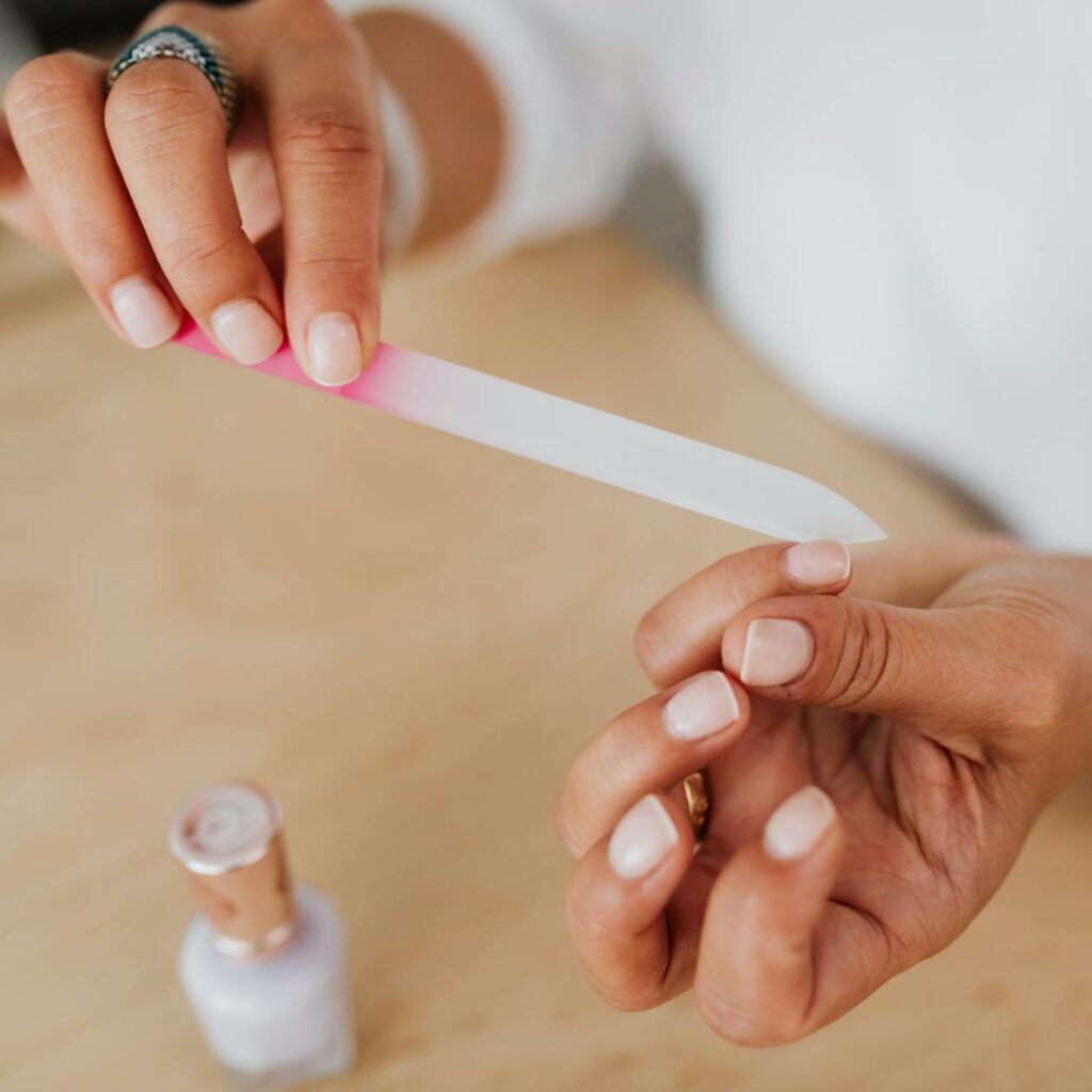 Person Holding White Nail File