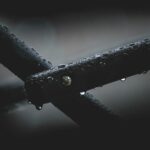 From Frail to Fabulous: Aloe Vera's Solution for Weak Nails Closeup of black metal pipes covered in water drops and attached with nail