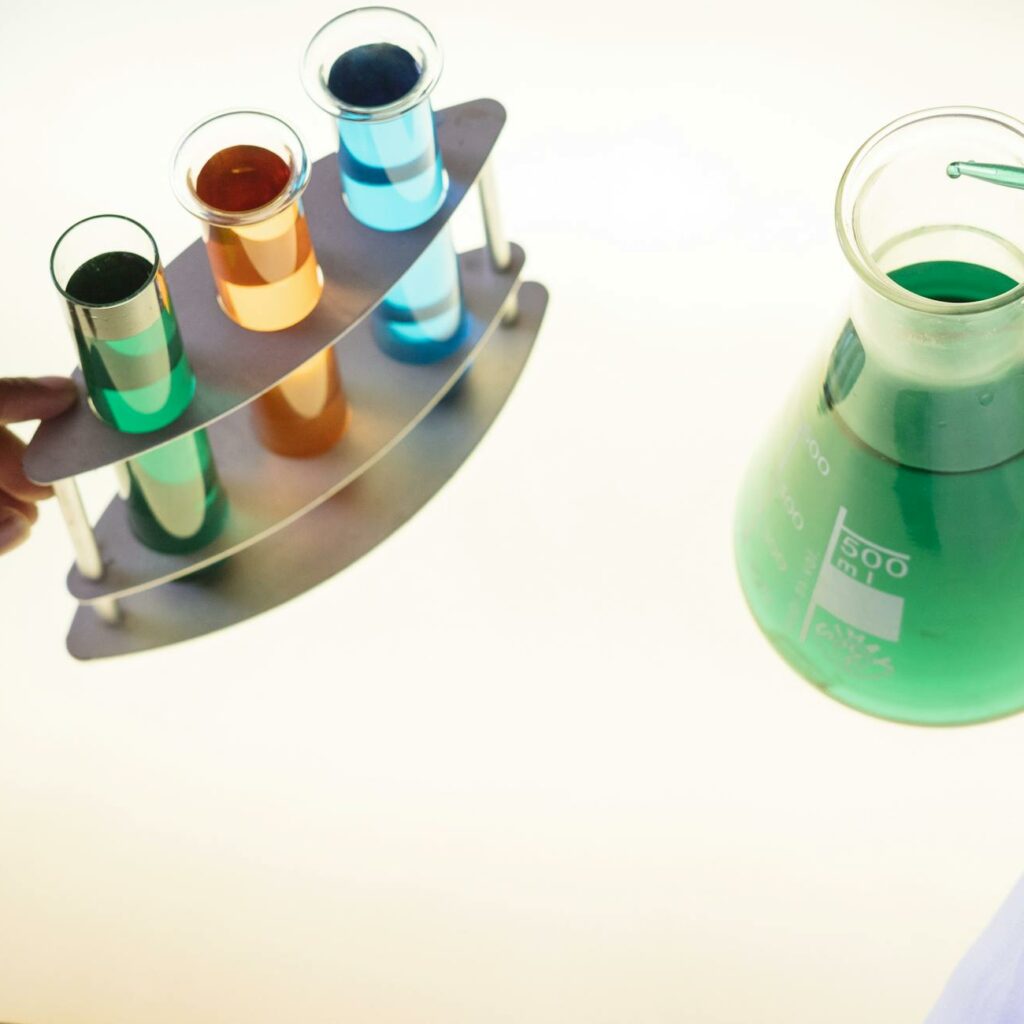 Crop laboratory technician examining interaction of chemicals in practical test modern lab