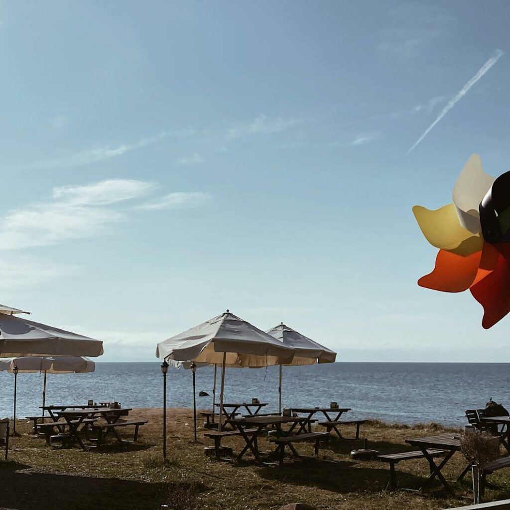 View of Tables and Chairs Standing on a Beach